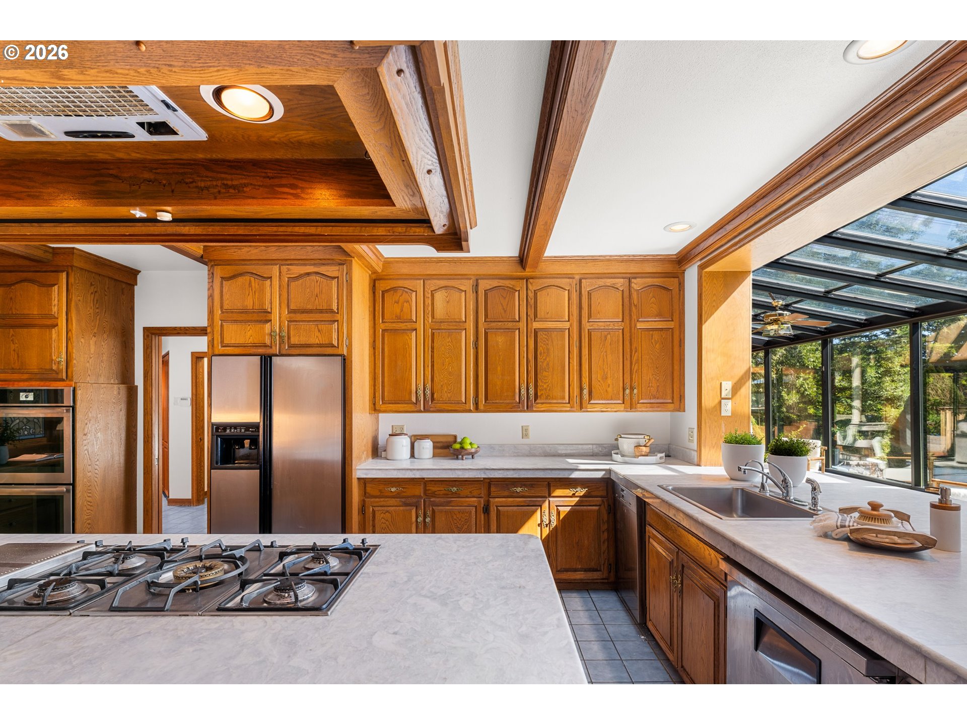 2732 Southwest Scholls Ferry Road Portland, OR 97221 - Photo 13 of 46 a kitchen with stainless steel appliances kitchen island granite countertop a refrigerator and a sink