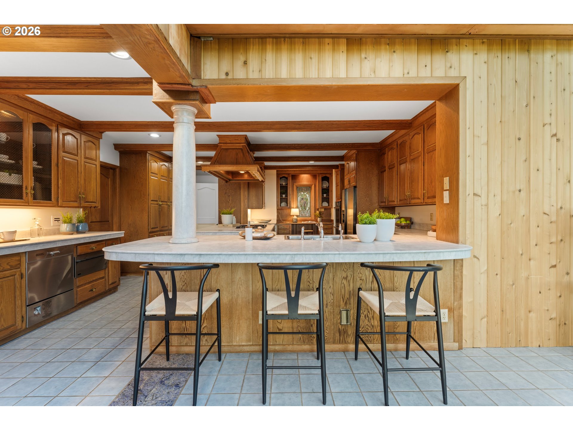 2732 Southwest Scholls Ferry Road Portland, OR 97221 - Photo 18 of 46 a dining hall with stainless steel appliances kitchen island a table and chairs