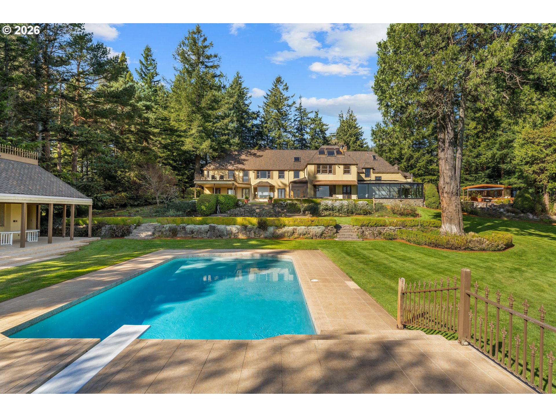 2732 Southwest Scholls Ferry Road Portland, OR 97221 - Photo 40 of 46 a view of a swimming pool with lawn chairs and a big yard