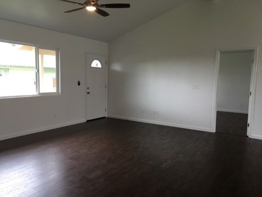 18-7892 Peleke Road Mountain View, HI 96771 - Photo 11 of 16 a view of an empty room with wooden floor and a window