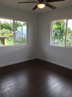 18-7892 Peleke Road Mountain View, HI 96771 - Photo 14 of 16 an empty room with wooden floor and windows