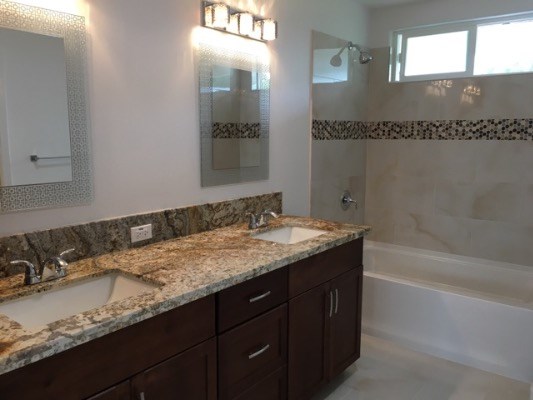 18-7892 Peleke Road Mountain View, HI 96771 - Photo 16 of 16 a bathroom with a granite countertop sink a mirror and a shower