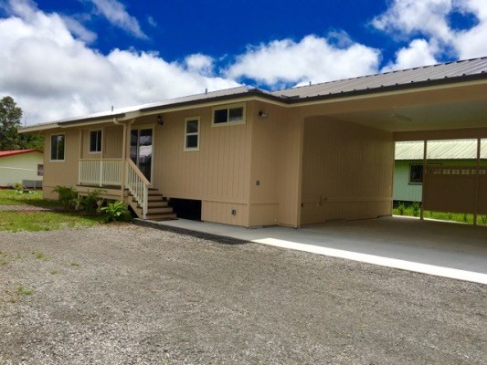 18-7892 Peleke Road Mountain View, HI 96771 - Photo 2 of 16 front view of a house with a street