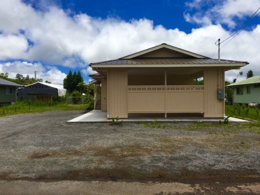 18-7892 Peleke Road Mountain View, HI 96771 - Photo 3 of 16 a front view of a house with a yard and garage