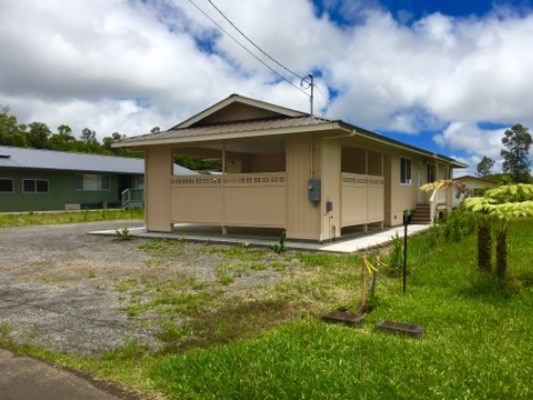 18-7892 Peleke Road Mountain View, HI 96771 - Photo 5 of 16 a yellow house with green field in front of it