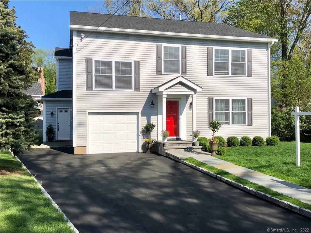3 Lillian Terrace Darien, CT 06820 - Photo 1 of 1 a front view of a house with a yard and garage