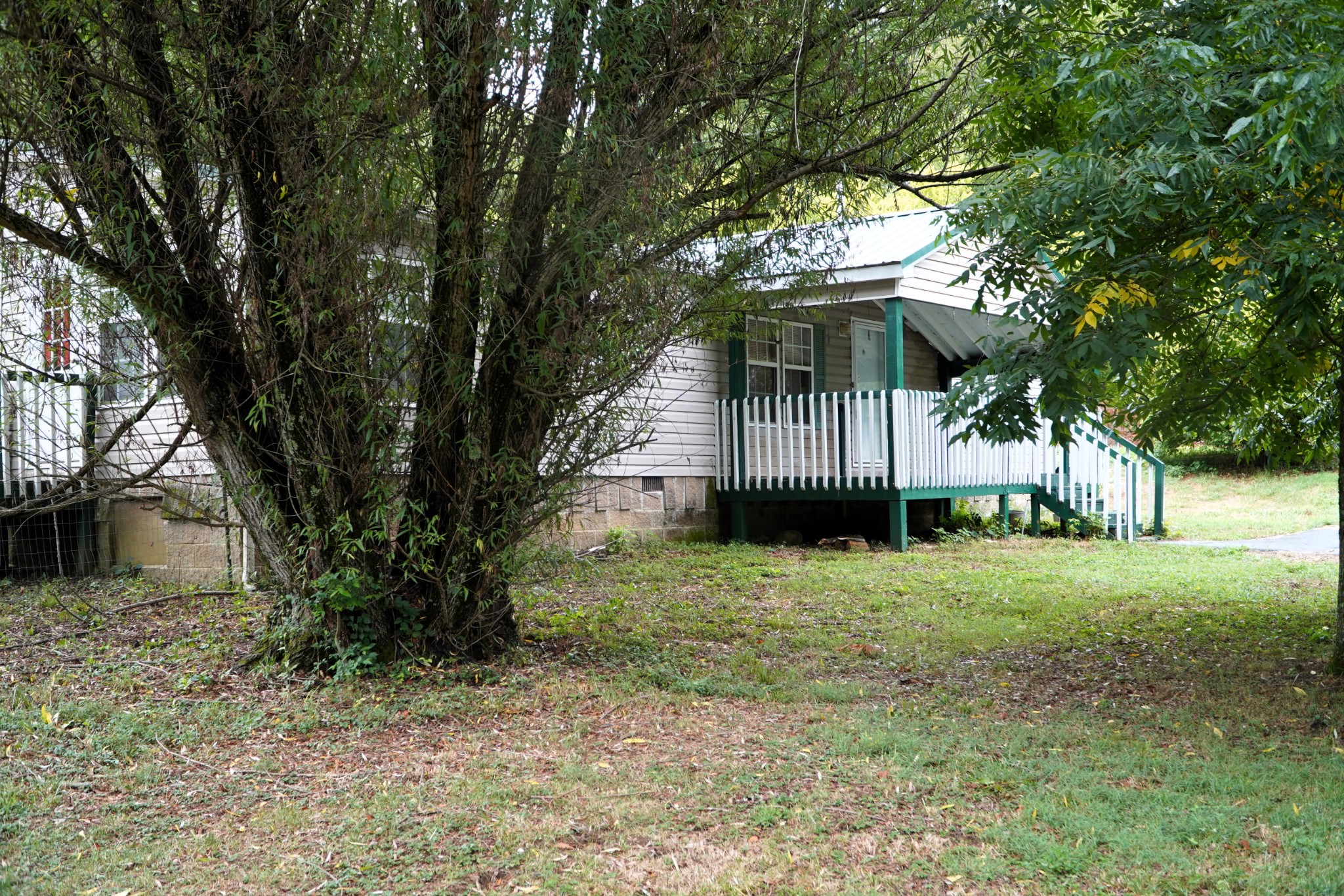 237 Red Oak Road Petersburg, TN 37144 - Photo 1 of 57 a white house that has a tree in front of it