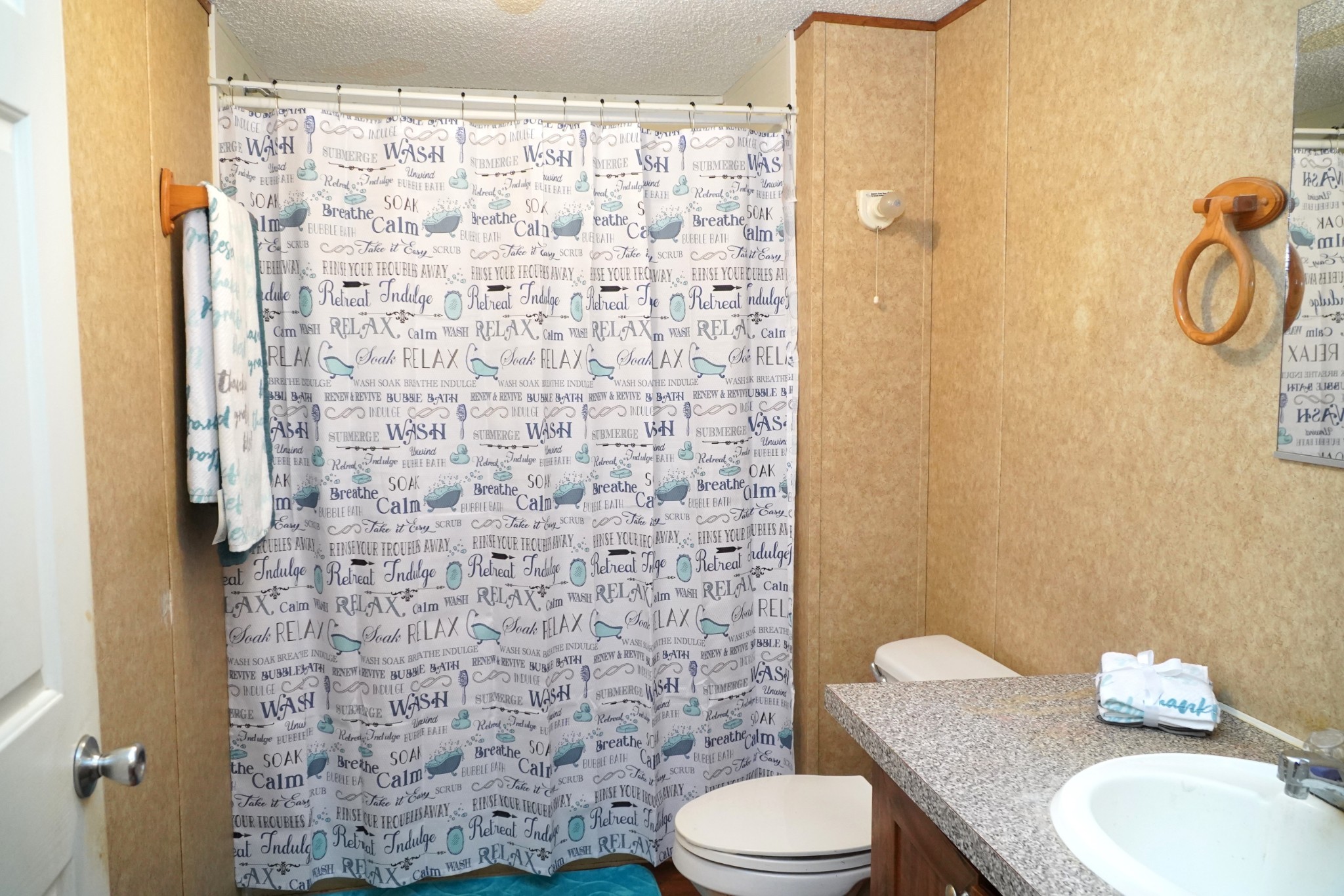 237 Red Oak Road Petersburg, TN 37144 - Photo 28 of 57 a bathroom with a granite countertop toilet and a shower curtain