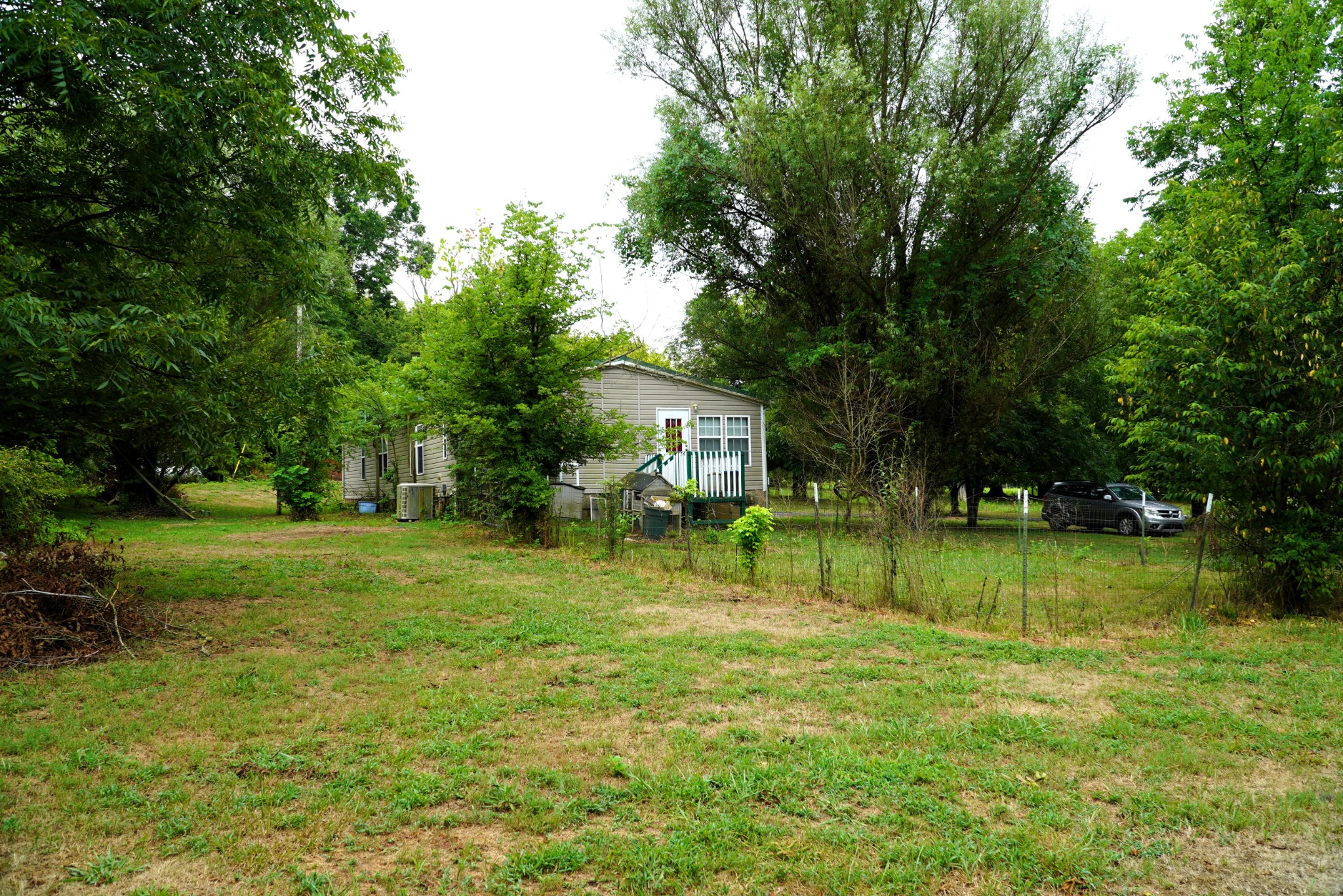 237 Red Oak Road Petersburg, TN 37144 - Photo 32 of 57 a view of a house with a big yard and a large trees