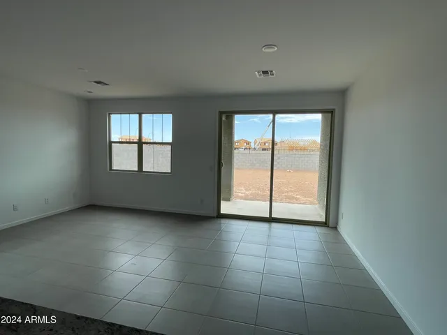 an empty room with windows and closet