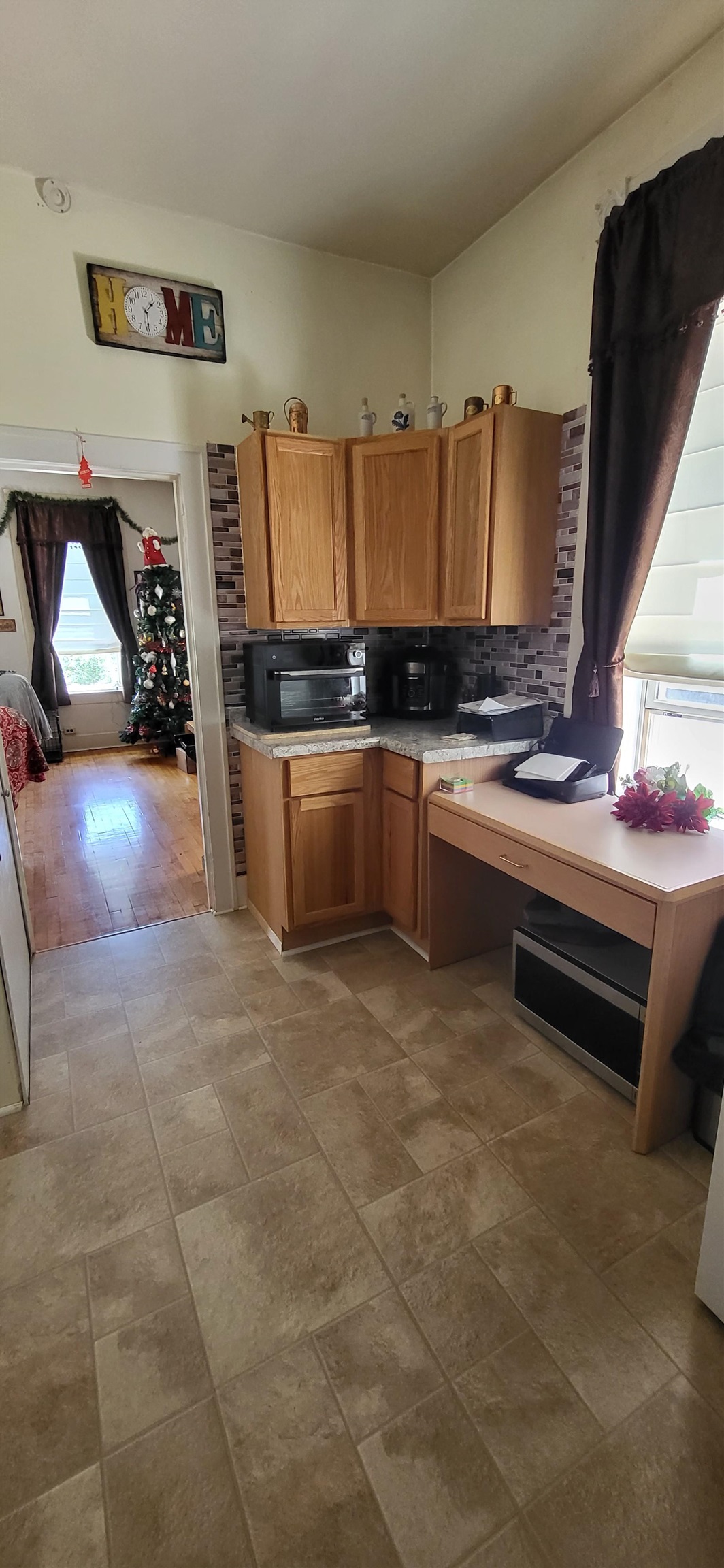 516 Main Street West Ashland, WI 54806 - Photo 10 of 11 Kitchen with brown cabinets, light countertops, and decorative backsplash