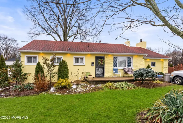 a front view of a house with a garden