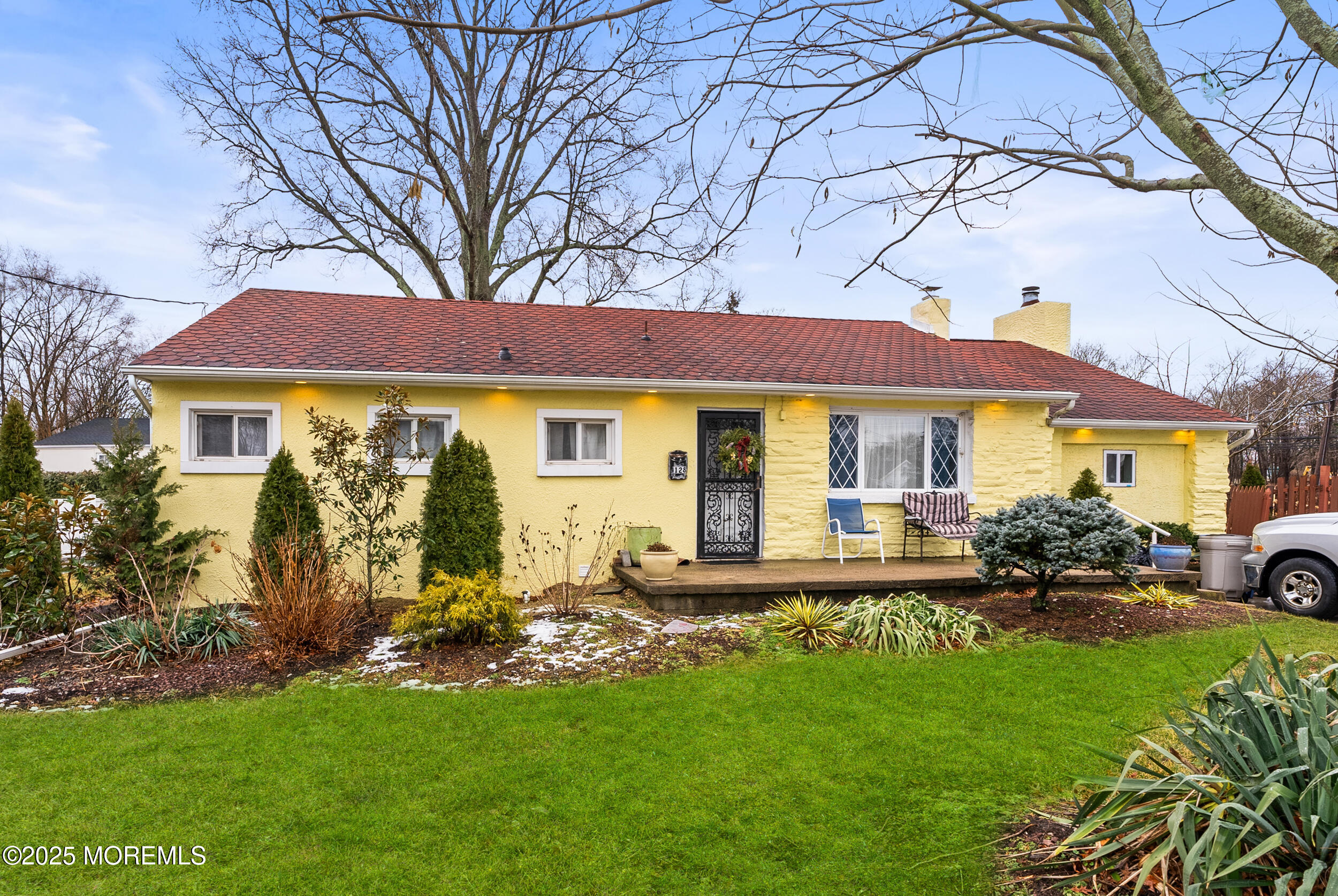 128 Beechwood Avenue West Long Branch, NJ 07764 - Photo 1 of 29 a front view of a house with a garden