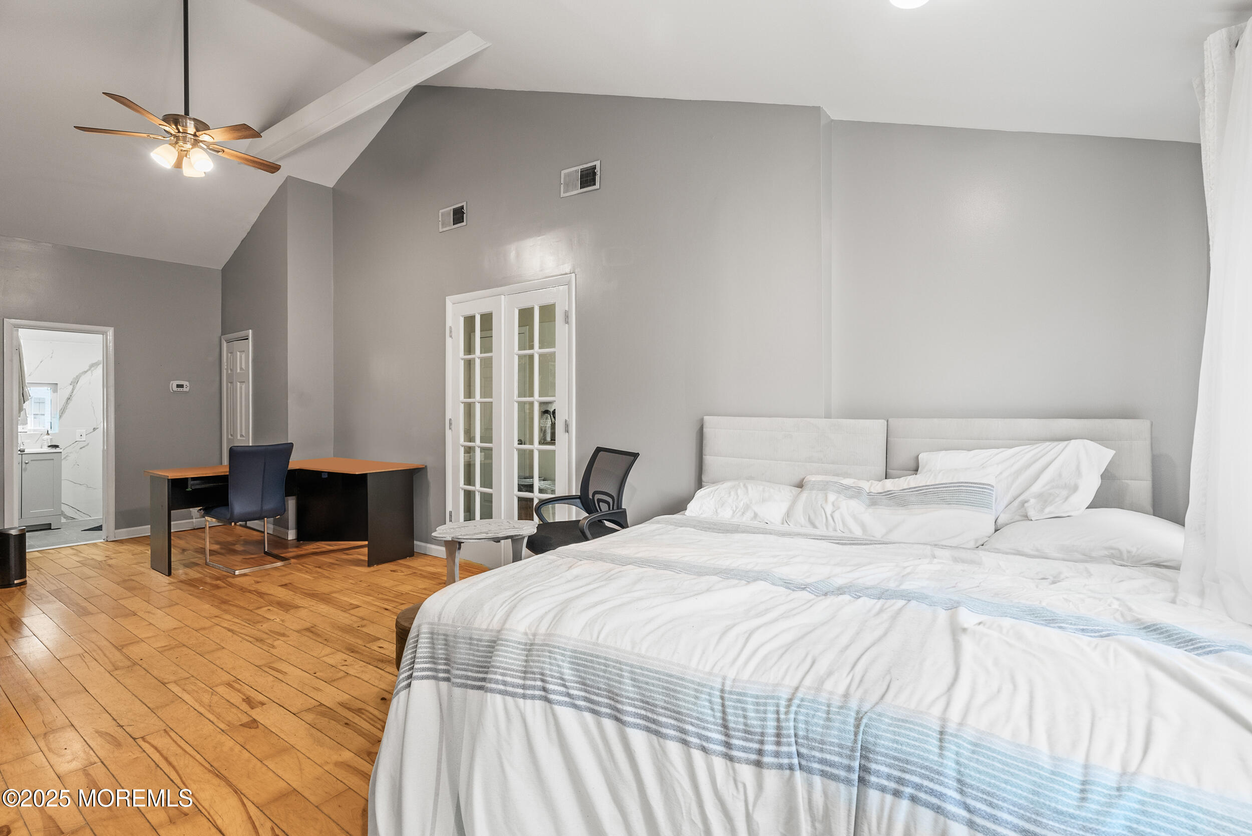 128 Beechwood Avenue West Long Branch, NJ 07764 - Photo 12 of 29 a bedroom with a bed and a chandelier