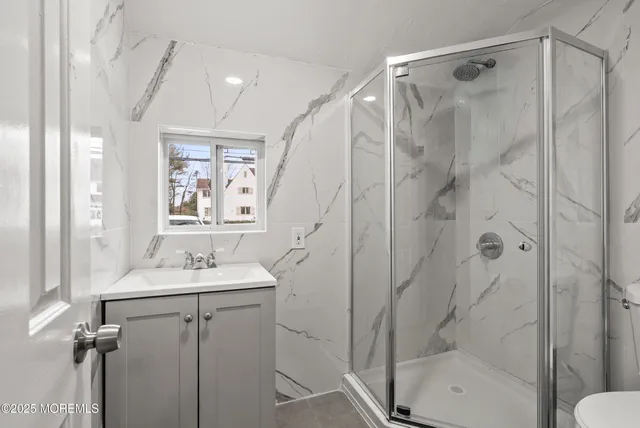 a bathroom with a sink a mirror and a shower