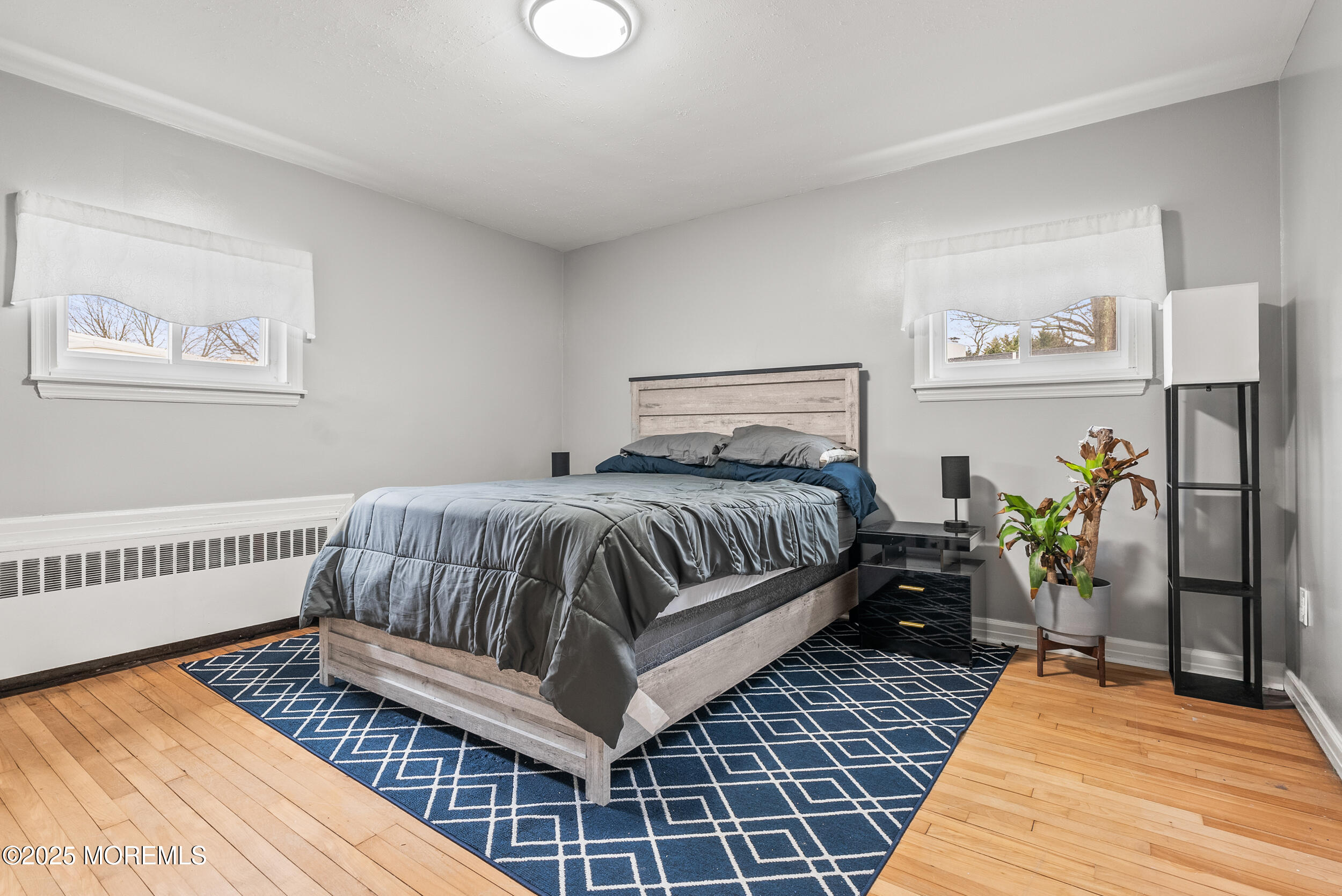 128 Beechwood Avenue West Long Branch, NJ 07764 - Photo 14 of 29 a bedroom with a bed and wooden floor