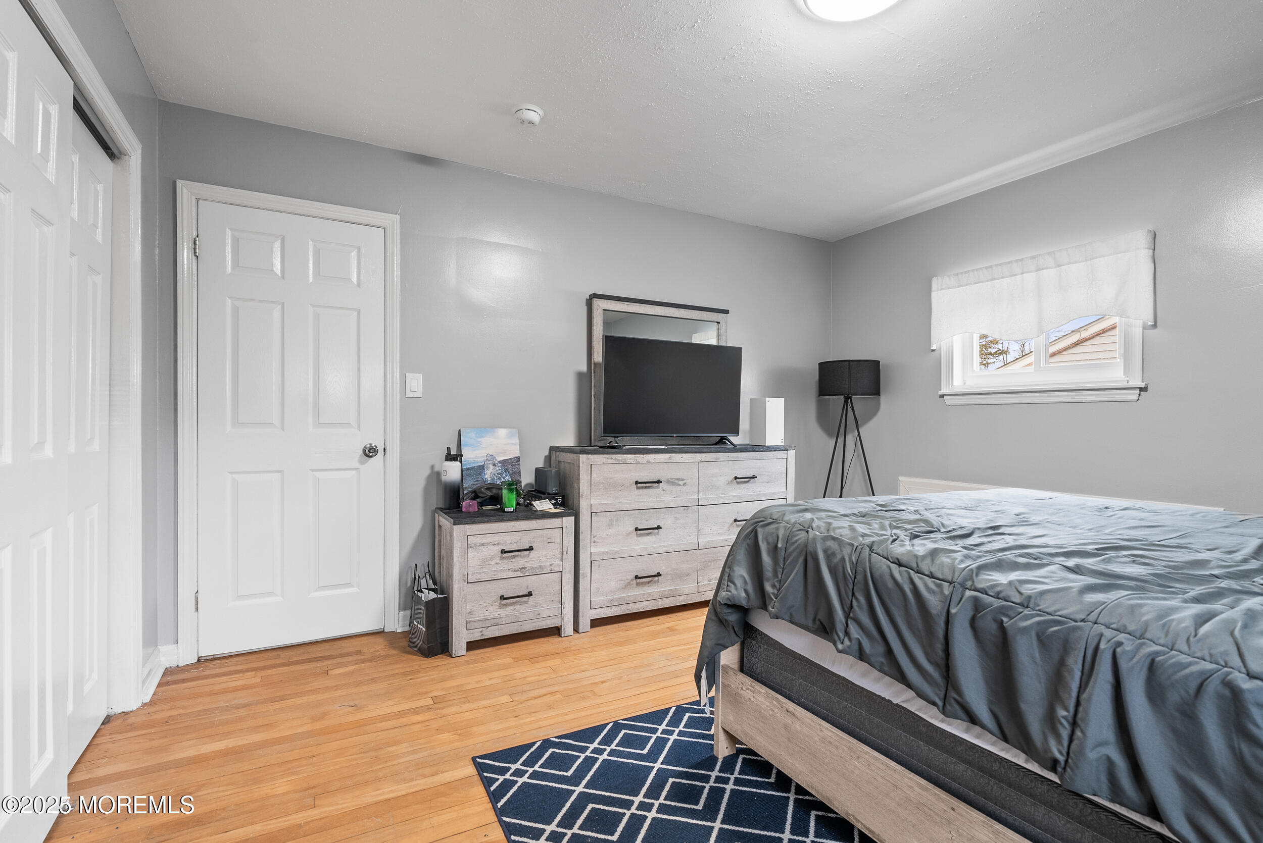 128 Beechwood Avenue West Long Branch, NJ 07764 - Photo 15 of 29 a bedroom with a bed and a flat screen tv