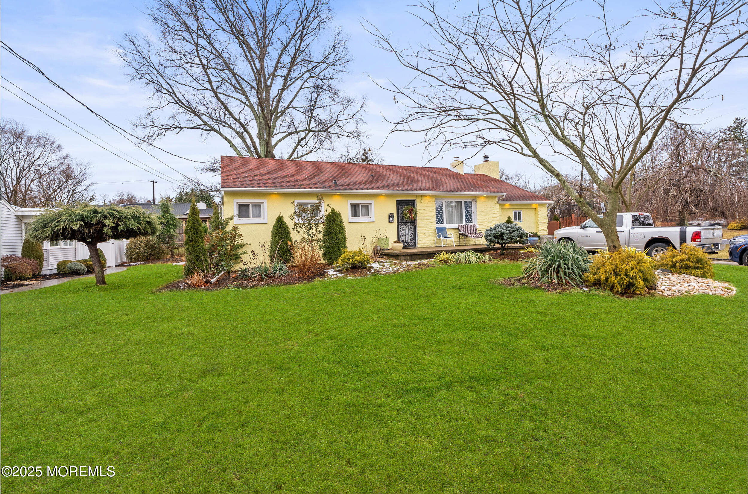 128 Beechwood Avenue West Long Branch, NJ 07764 - Photo 24 of 29 a view of a yard with a table and chairs and a large tree