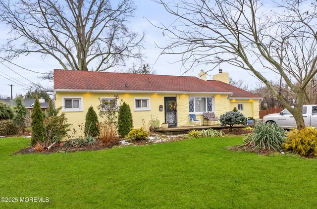 a front view of house with a garden