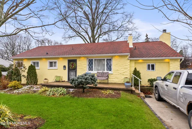 a front view of house with yard and outdoor seating