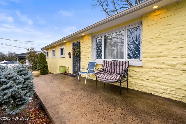 a balcony with couple of chairs and a wooden floor
