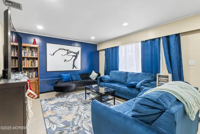 a living room with furniture and large window