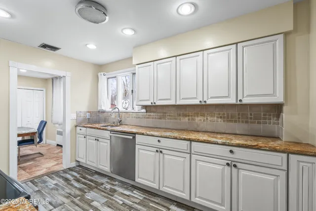a kitchen with white cabinets