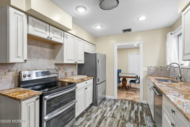 a kitchen with a stove and a refrigerator