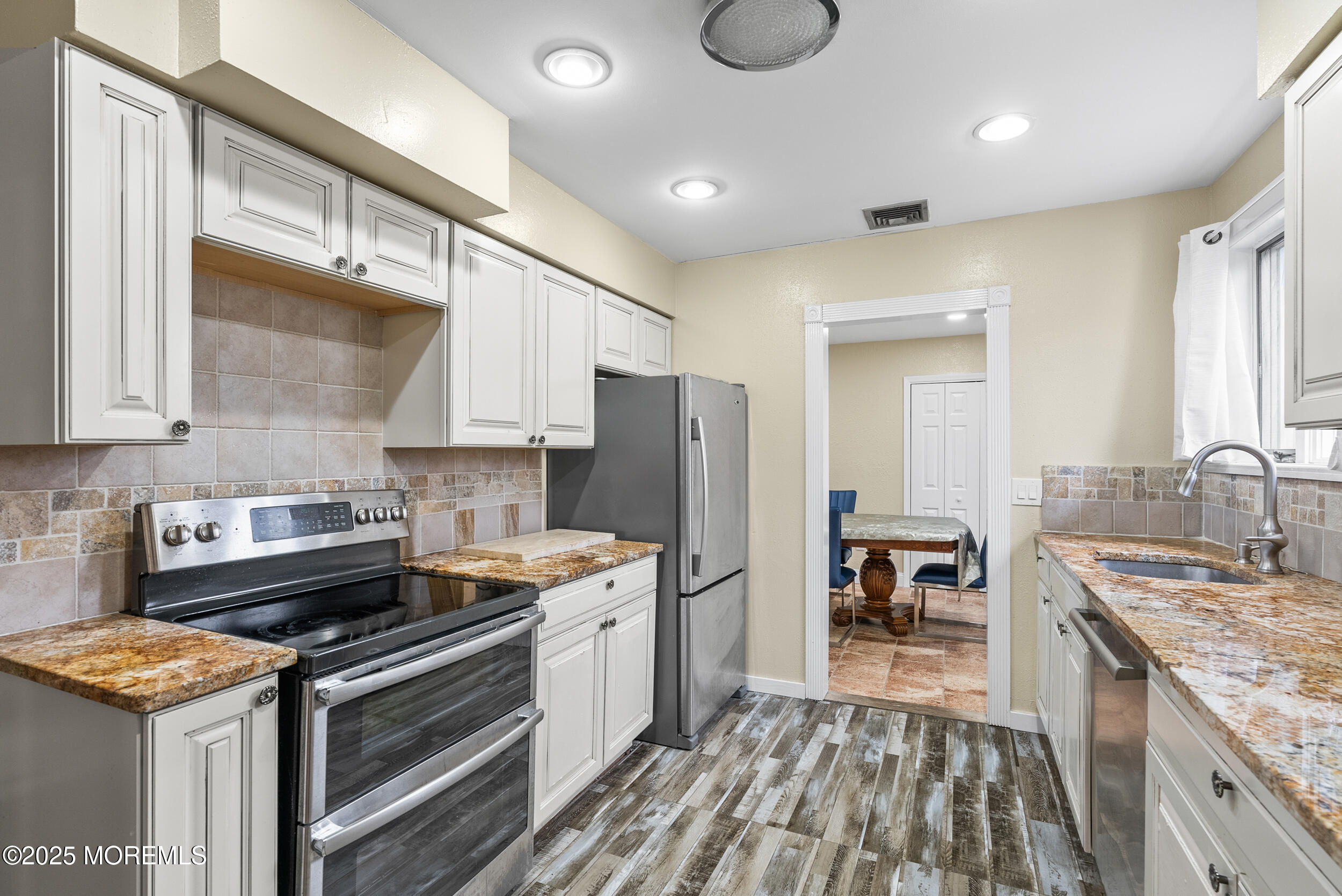 128 Beechwood Avenue West Long Branch, NJ 07764 - Photo 8 of 29 a kitchen with a stove and a refrigerator