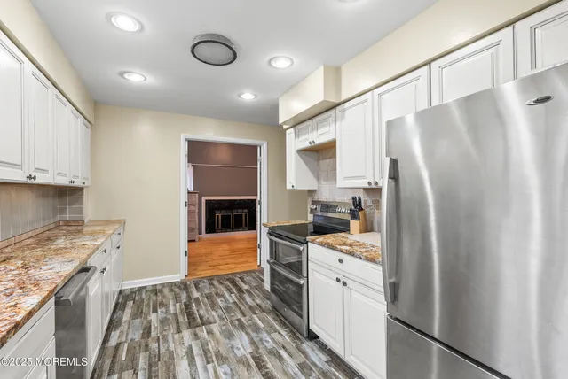 a kitchen with stainless steel appliances a refrigerator and a stove top oven