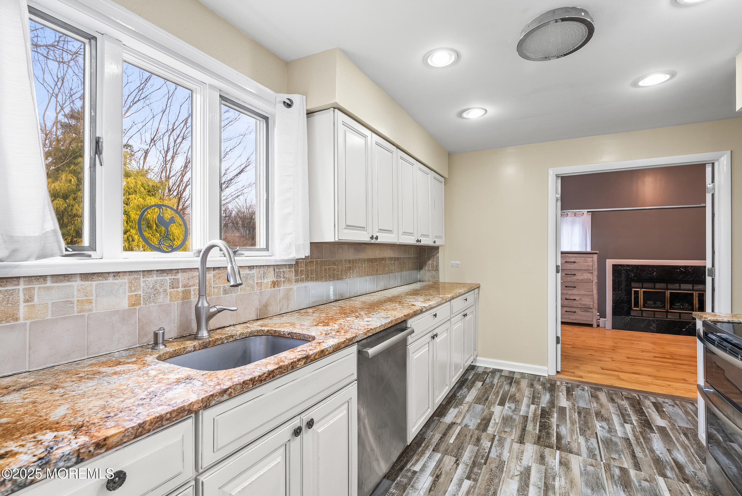 128 Beechwood Avenue West Long Branch, NJ 07764 - Photo 10 of 29 a kitchen with granite countertop a sink a counter space appliances and cabinets