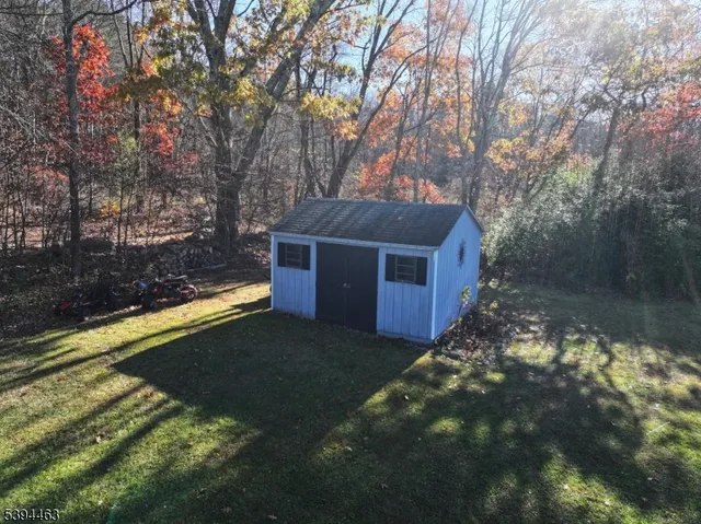 a bedroom with bed and a chandelier