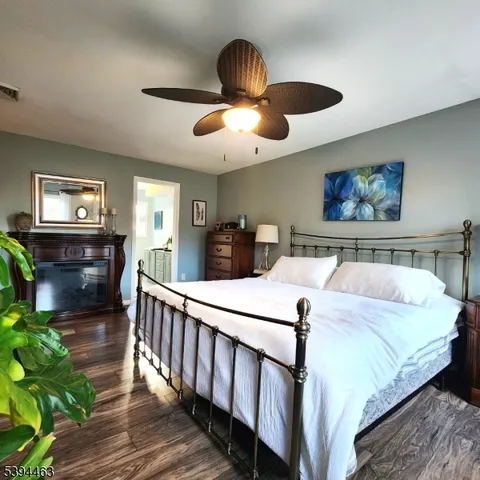 a view of a house with a big yard and large trees