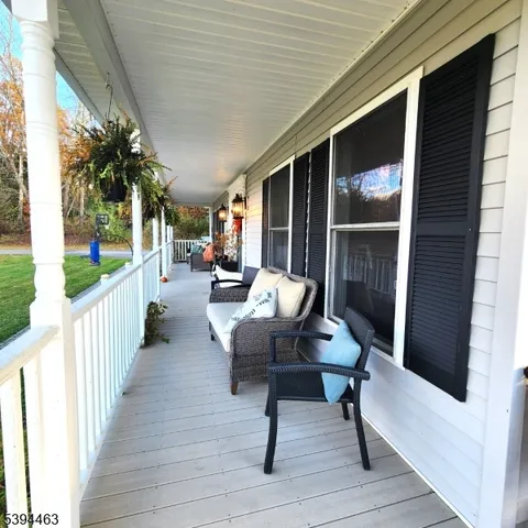 a view of a porch with chairs and backyard