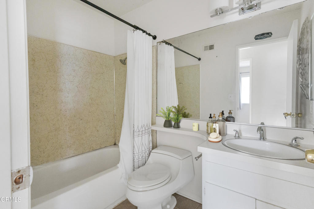 29443 Abelia Road Canyon Country, CA 91387 - Photo 17 of 31 a bathroom with a granite countertop sink a toilet and shower
