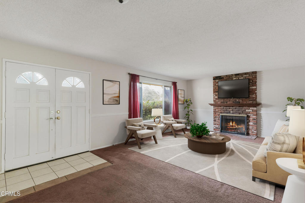 29443 Abelia Road Canyon Country, CA 91387 - Photo 4 of 31 a living room with furniture a flat screen tv and a potted plant