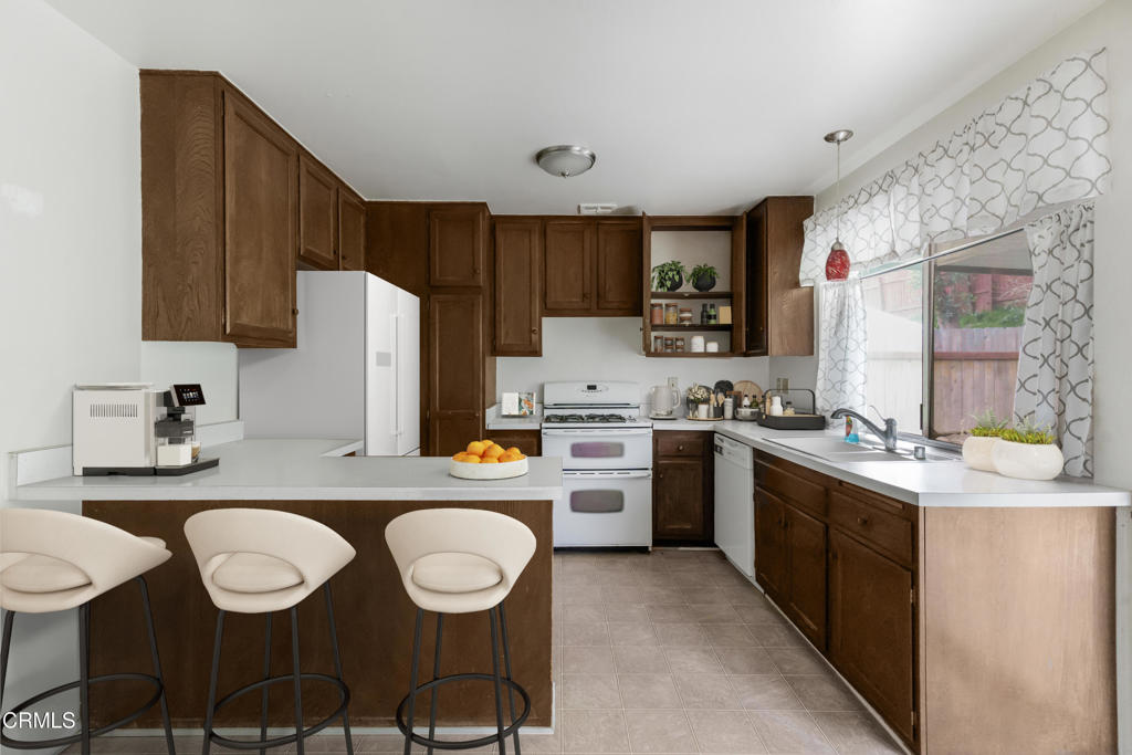 29443 Abelia Road Canyon Country, CA 91387 - Photo 7 of 31 a kitchen with a dining table and chairs