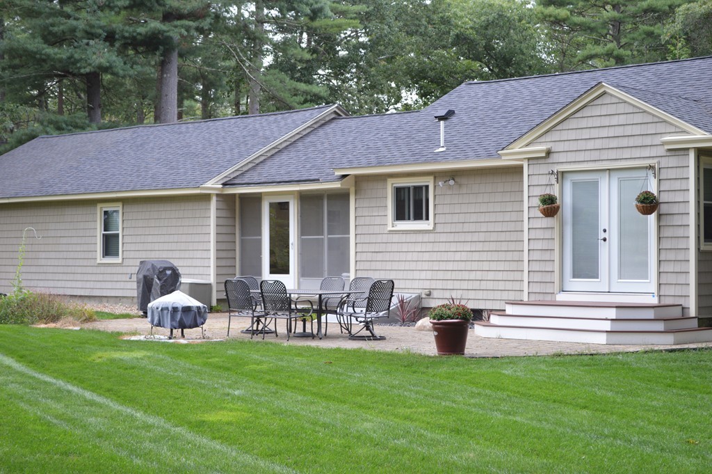 215 Hudson Road Sudbury, MA 01776 - Photo 2 of 18 a front view of house with yard and outdoor seating