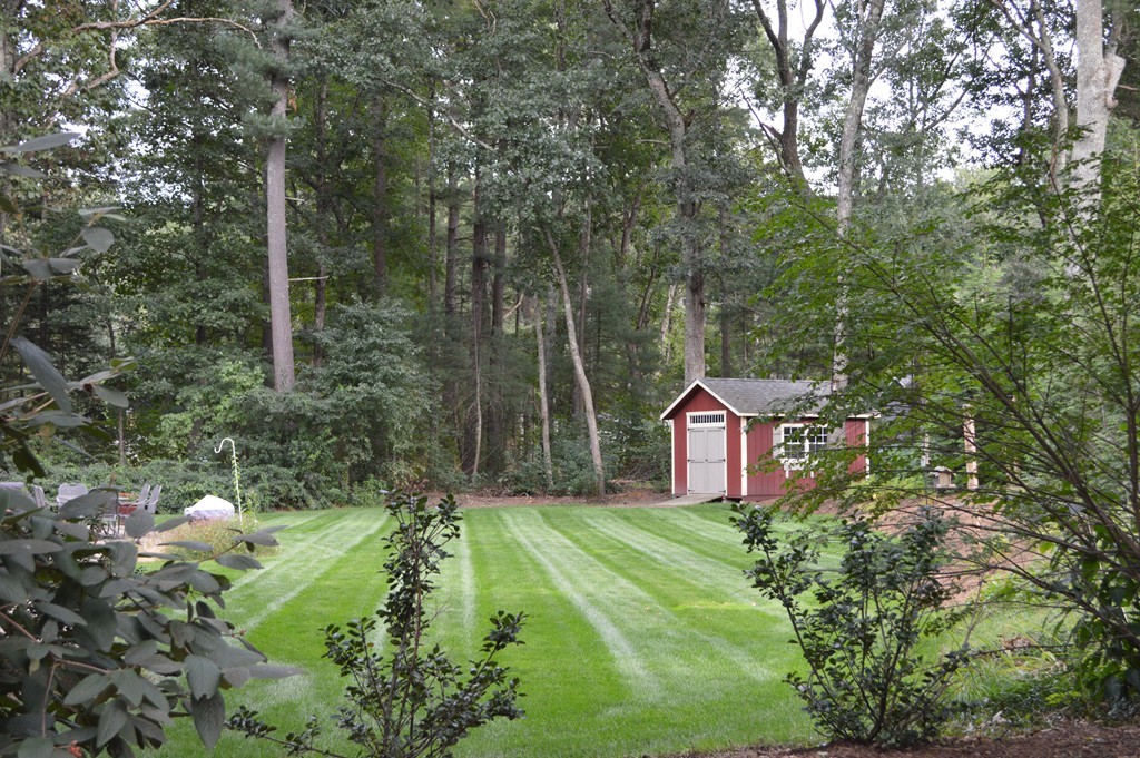 215 Hudson Road Sudbury, MA 01776 - Photo 3 of 18 a pathway of a house with a yard