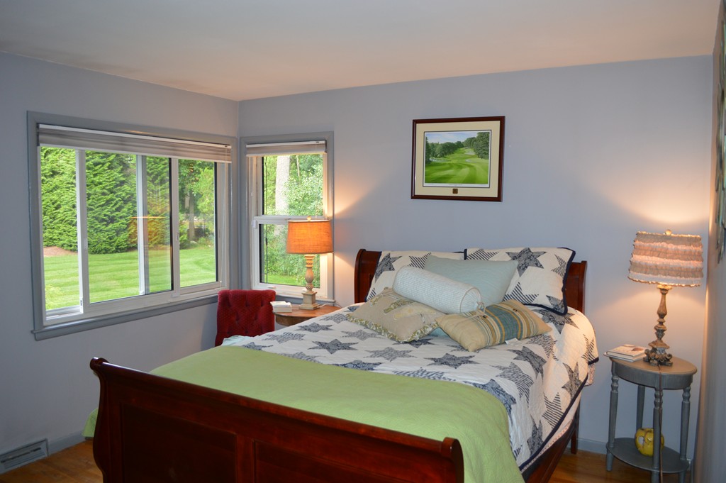 215 Hudson Road Sudbury, MA 01776 - Photo 10 of 18 a bedroom with a bed and a lamp next to a window