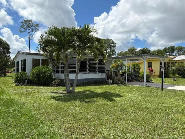 a view of a house with backyard