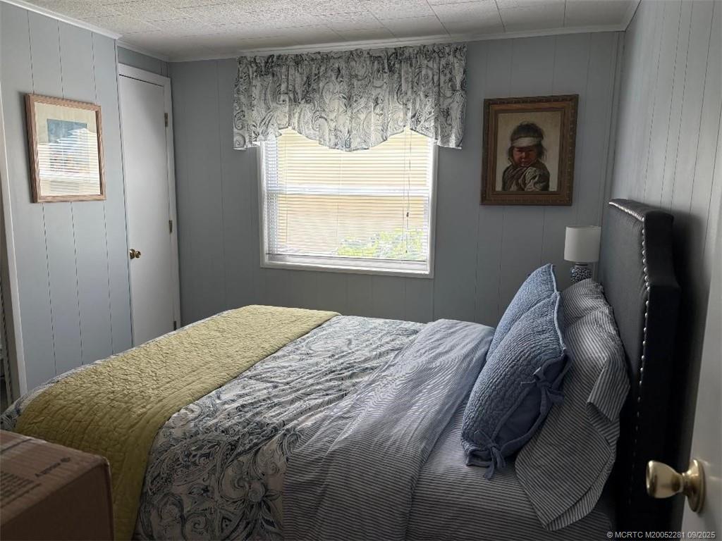 2686 Southwest Monarch Trail Stuart, FL 34997 - Photo 13 of 15 a bed sitting in a bedroom next to a window