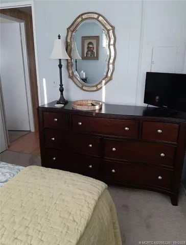 a living room with furniture and large windows