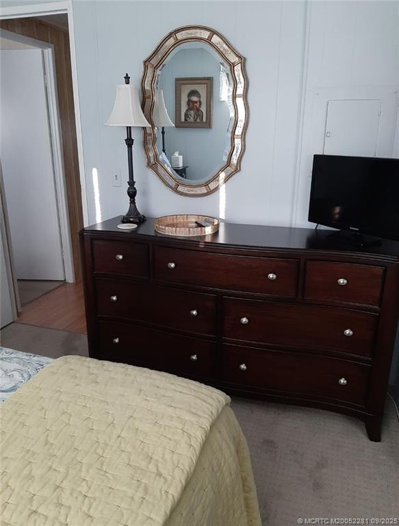 2686 Southwest Monarch Trail Stuart, FL 34997 - Photo 14 of 15 a living room with a mirror and a dresser