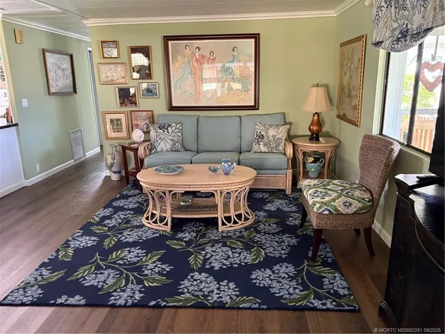 a dining room with furniture a mirror and wooden floor