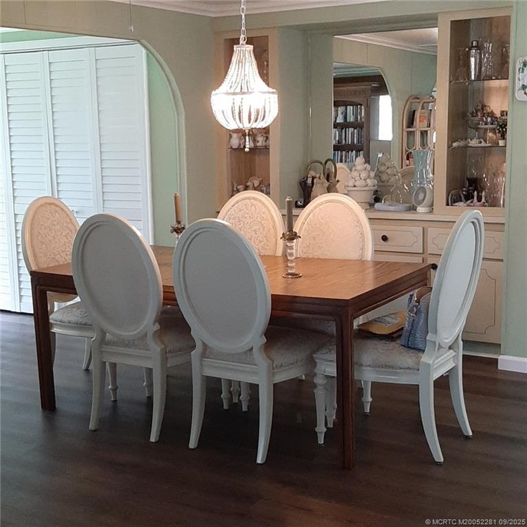 2686 Southwest Monarch Trail Stuart, FL 34997 - Photo 8 of 15 a dining room with furniture a mirror and wooden floor