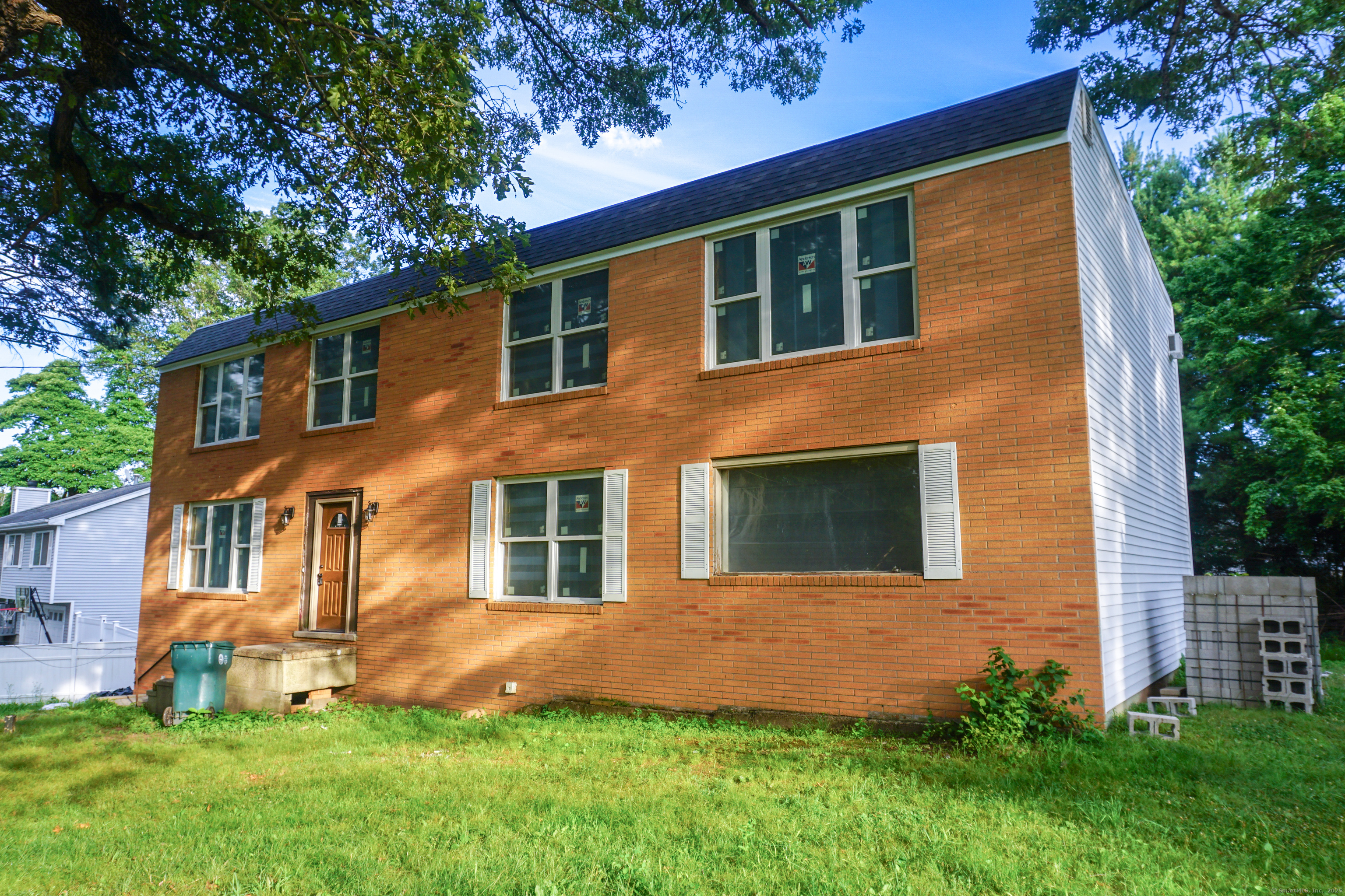 110 Dickerman Street Hamden, CT 06518 - Photo 2 of 11 a front view of a house with a yard and garage