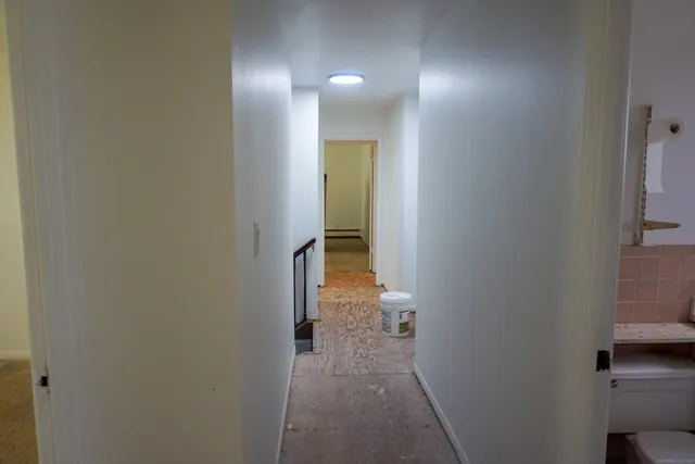 a view of a hallway with a room