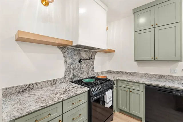 a kitchen with granite countertop a sink and a stove