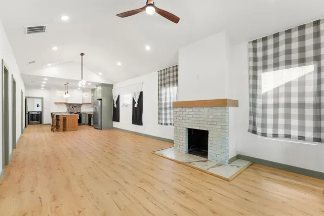 a view of a livingroom with a fireplace and window